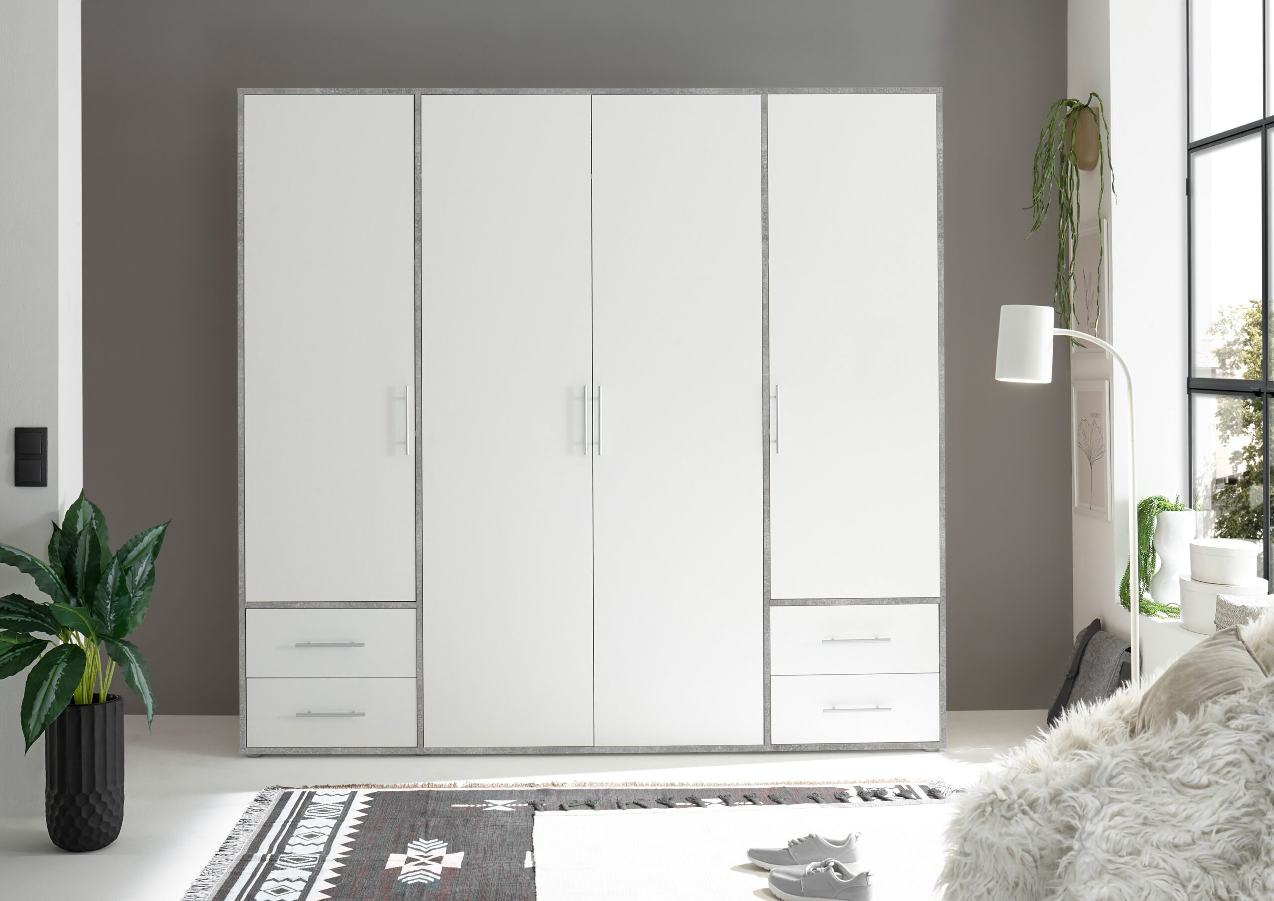 Moderne witte kast met grijze rand en lades in een minimalistische woonkamer bij Belga Meubel Brugge