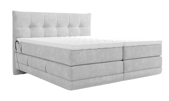 Lichtgrijze boxspring met gestoffeerd hoofdbord en comfortabele matras, verkrijgbaar bij Belga Meubel Brugge